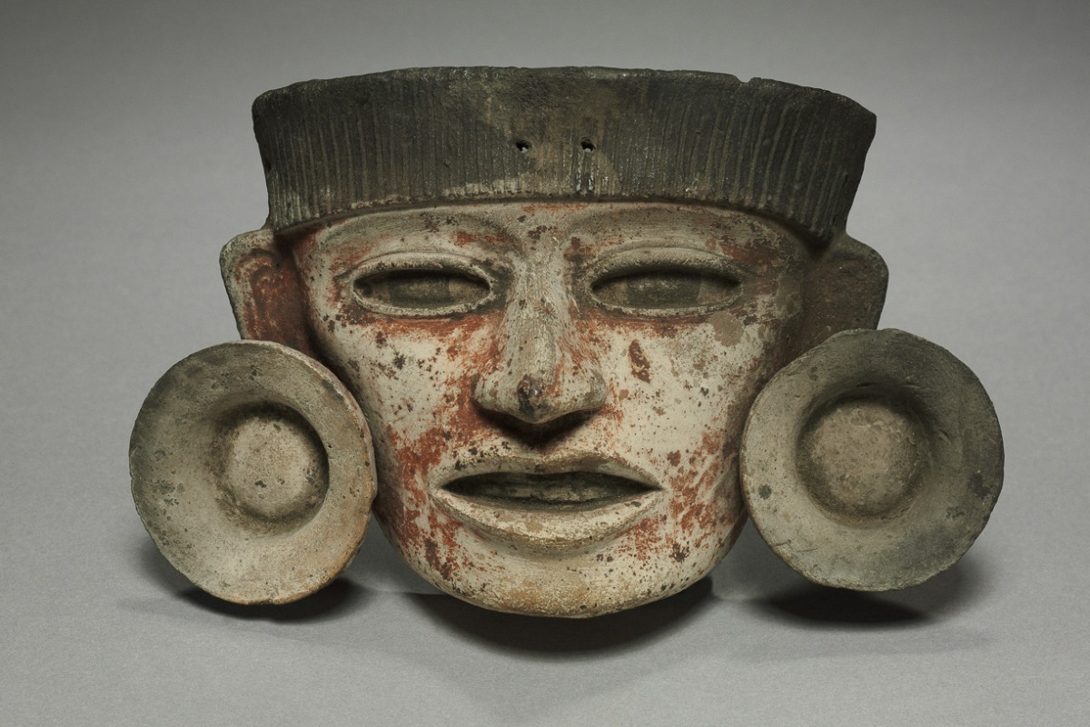 Pre-Columbian ceramic funerary mask exhibit at Café de Olla, San Francisco
