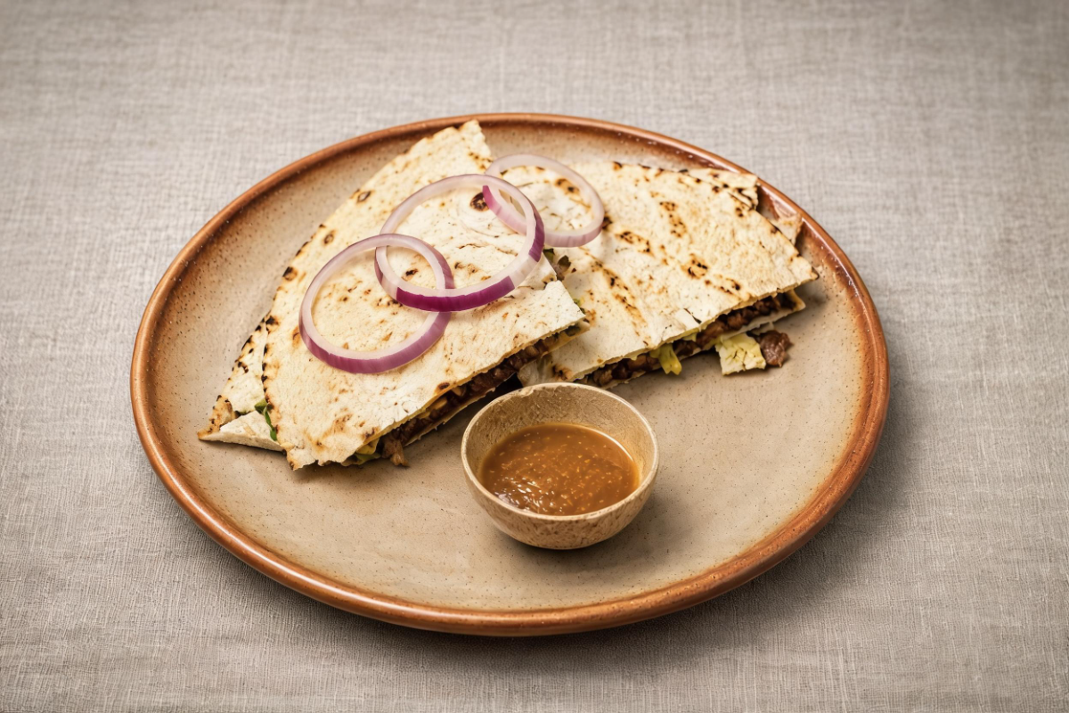 Oaxacan quesadilla plated with salsa at Café de Olla, San Francisco